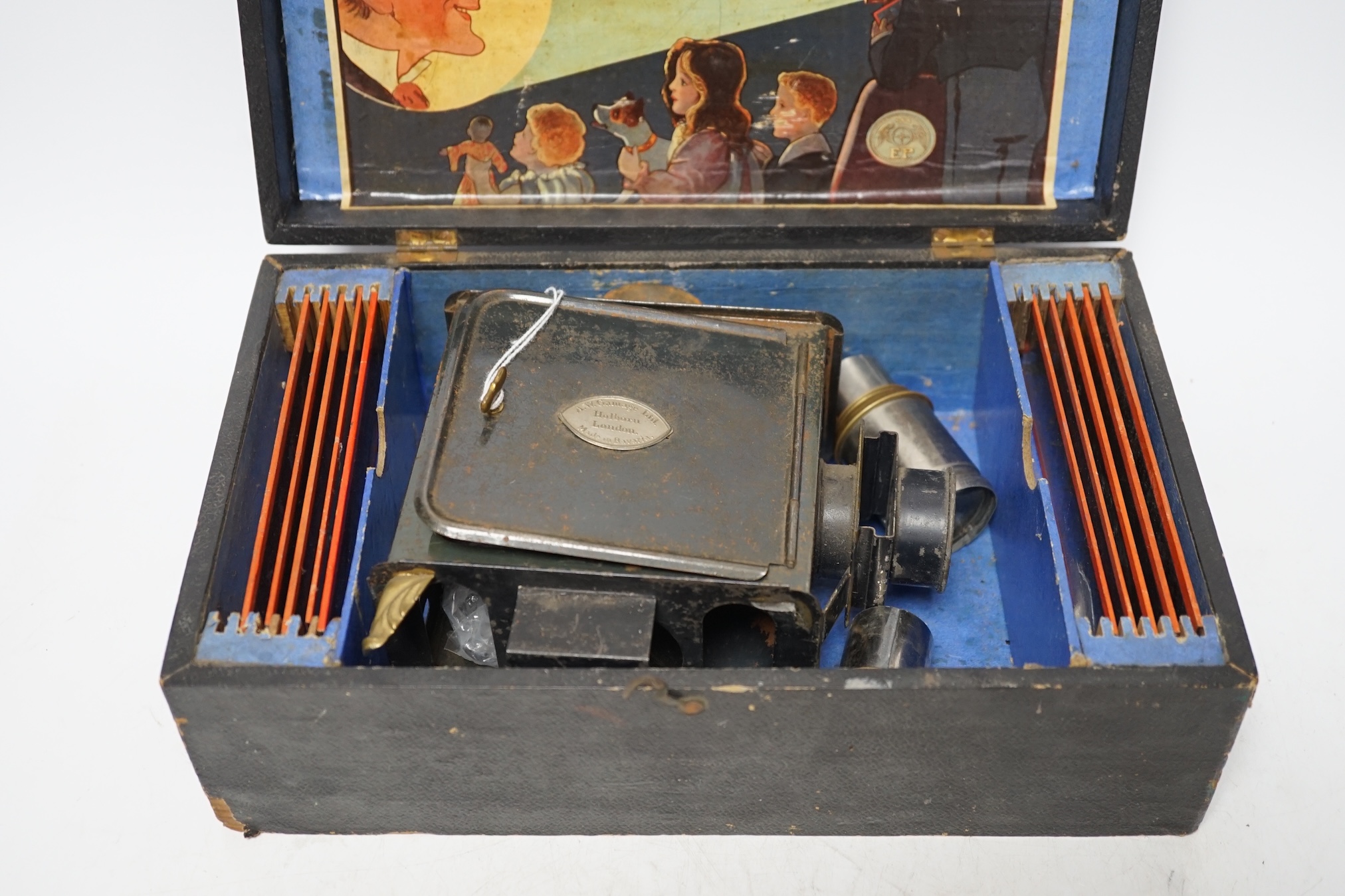 From the Studio of Fred Cuming. Vintage E.P. magic lantern and slides, cased. Condition - fair